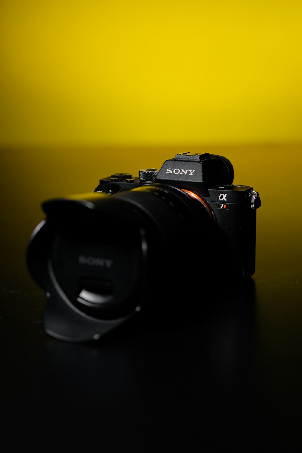 black nikon dslr camera on black surface