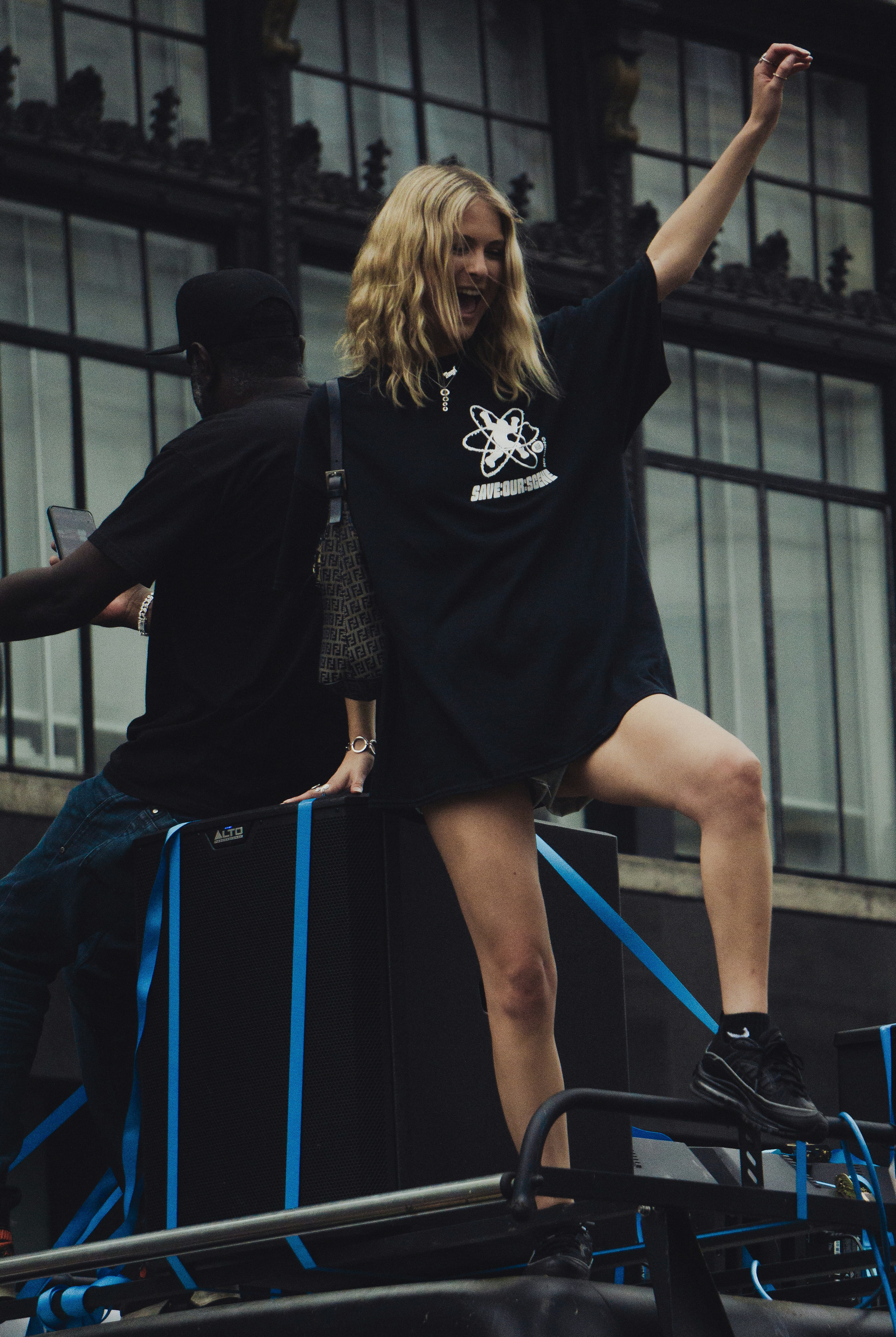 woman in black t-shirt and blue skirt