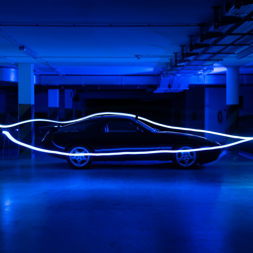 white and black coupe in a tunnel