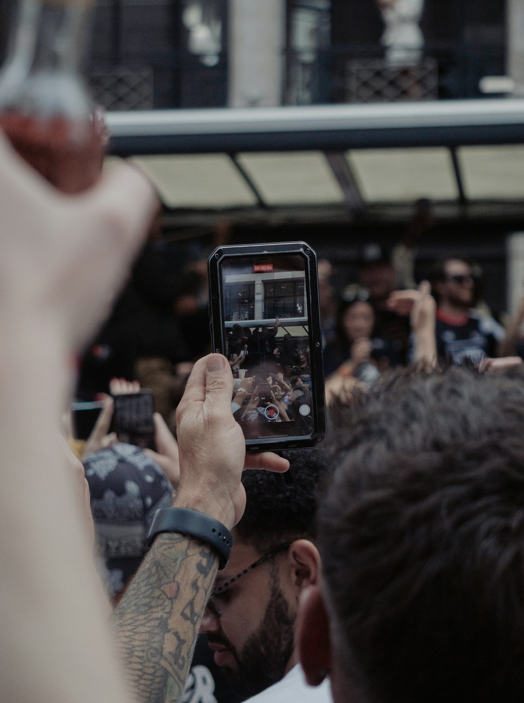 man taking photo of people in train