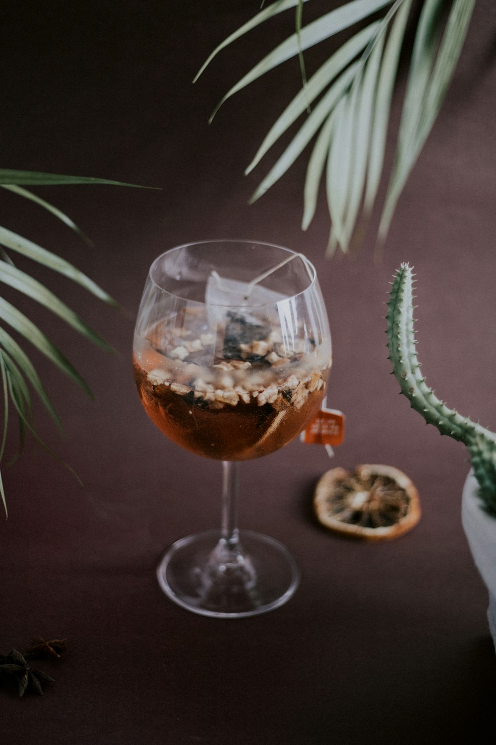 clear wine glass with brown liquid