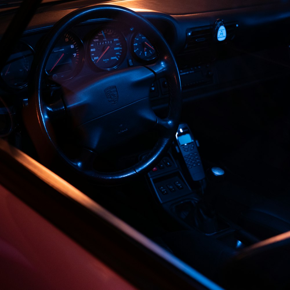 black car steering wheel during night time