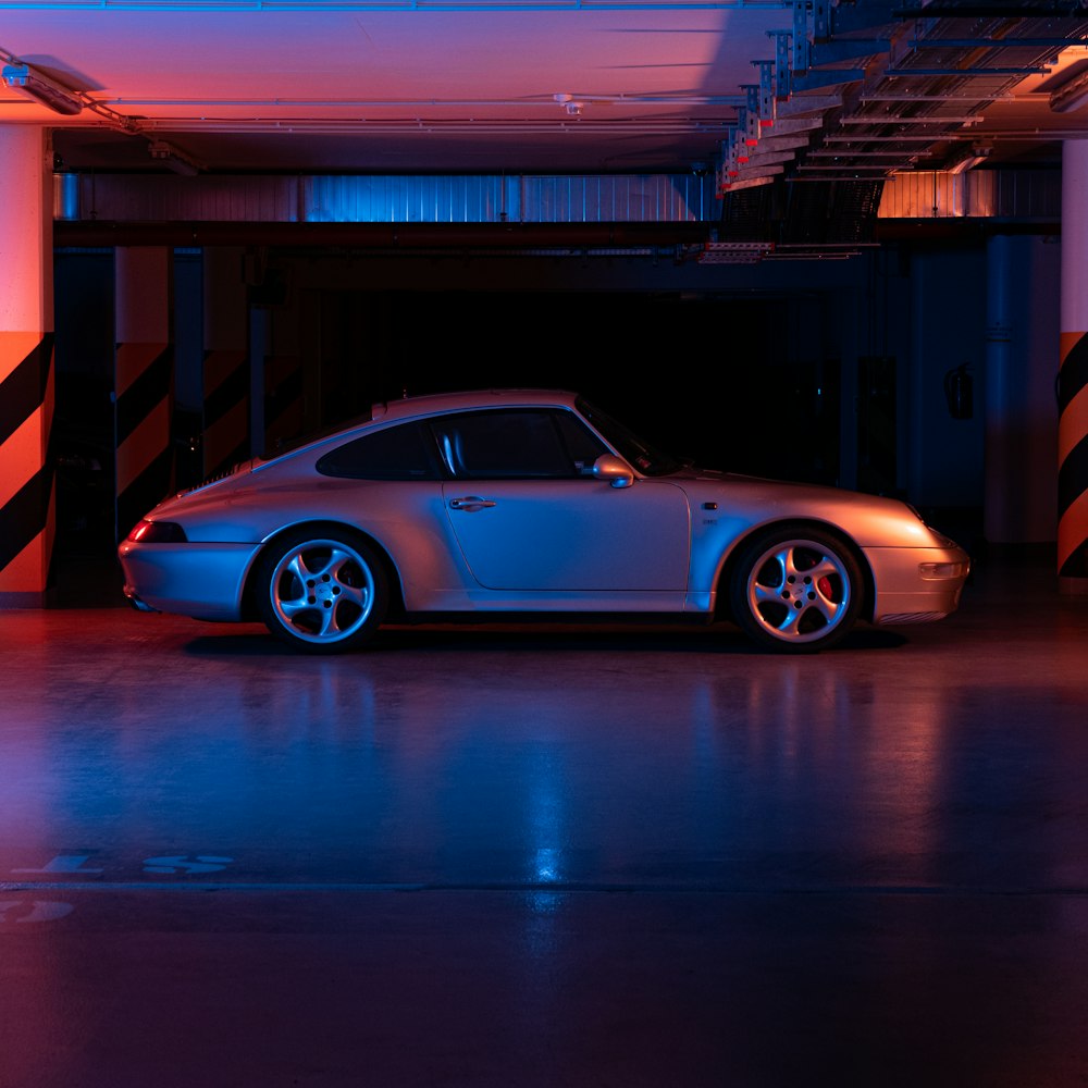 blue porsche 911 parked in a parking lot