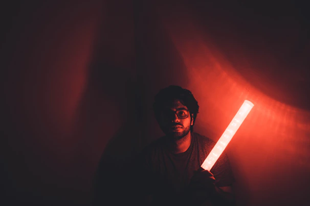 The magic seeing stick 𐤎 glowing mysteriously in a dim room filled with eclectic objects.