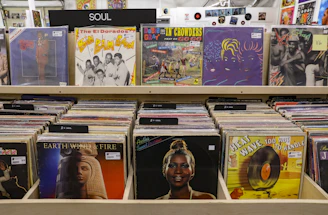 woman in orange shirt standing beside books