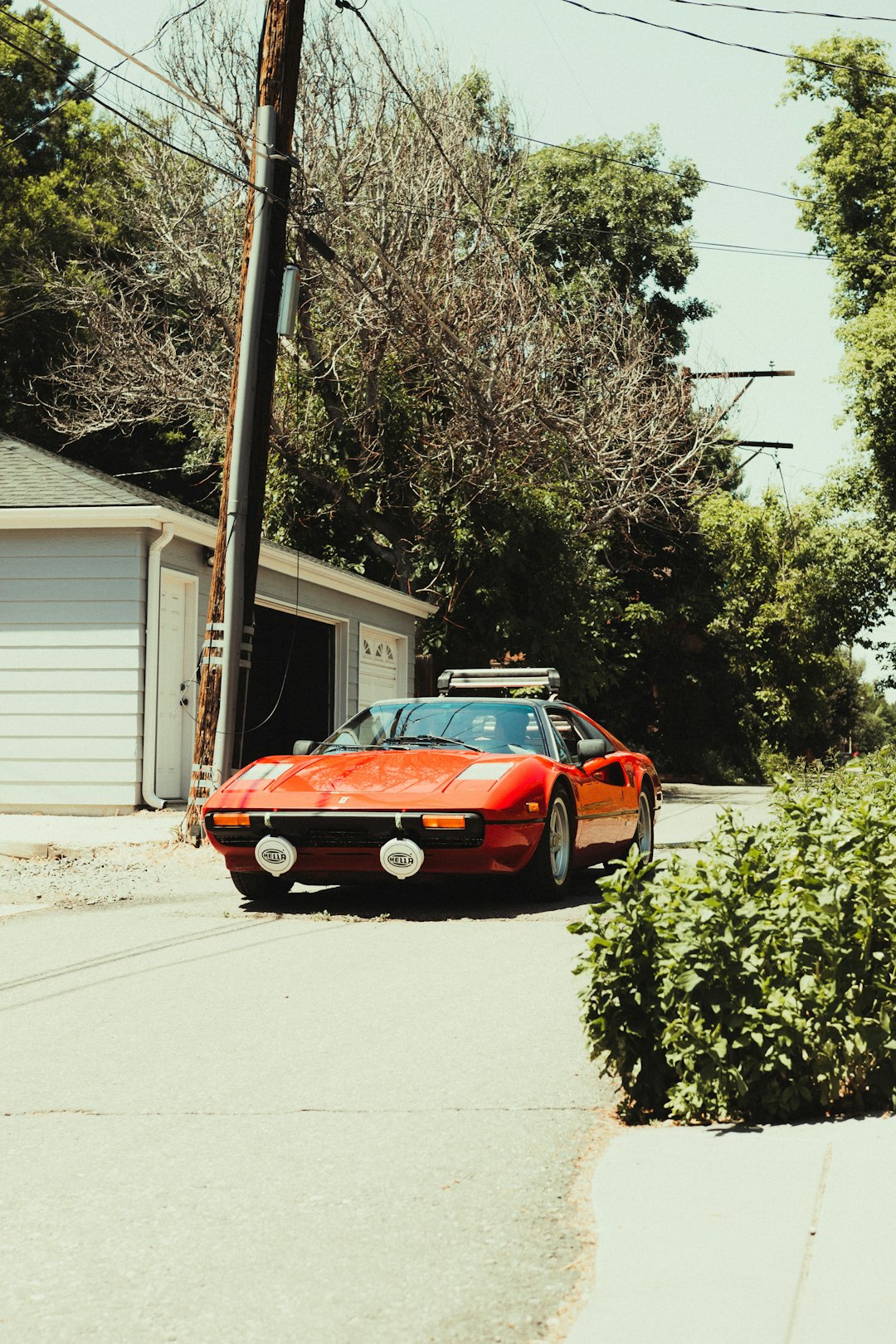 orange chevrolet camaro parked on roadside during daytime