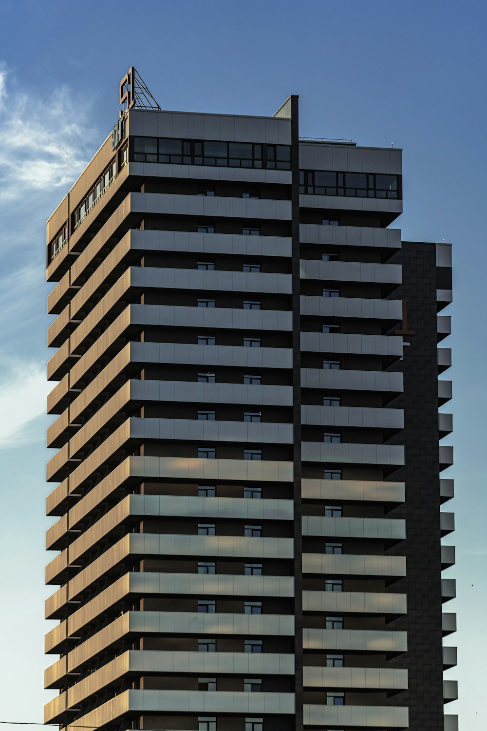 brown and black concrete building under blue sky during daytime