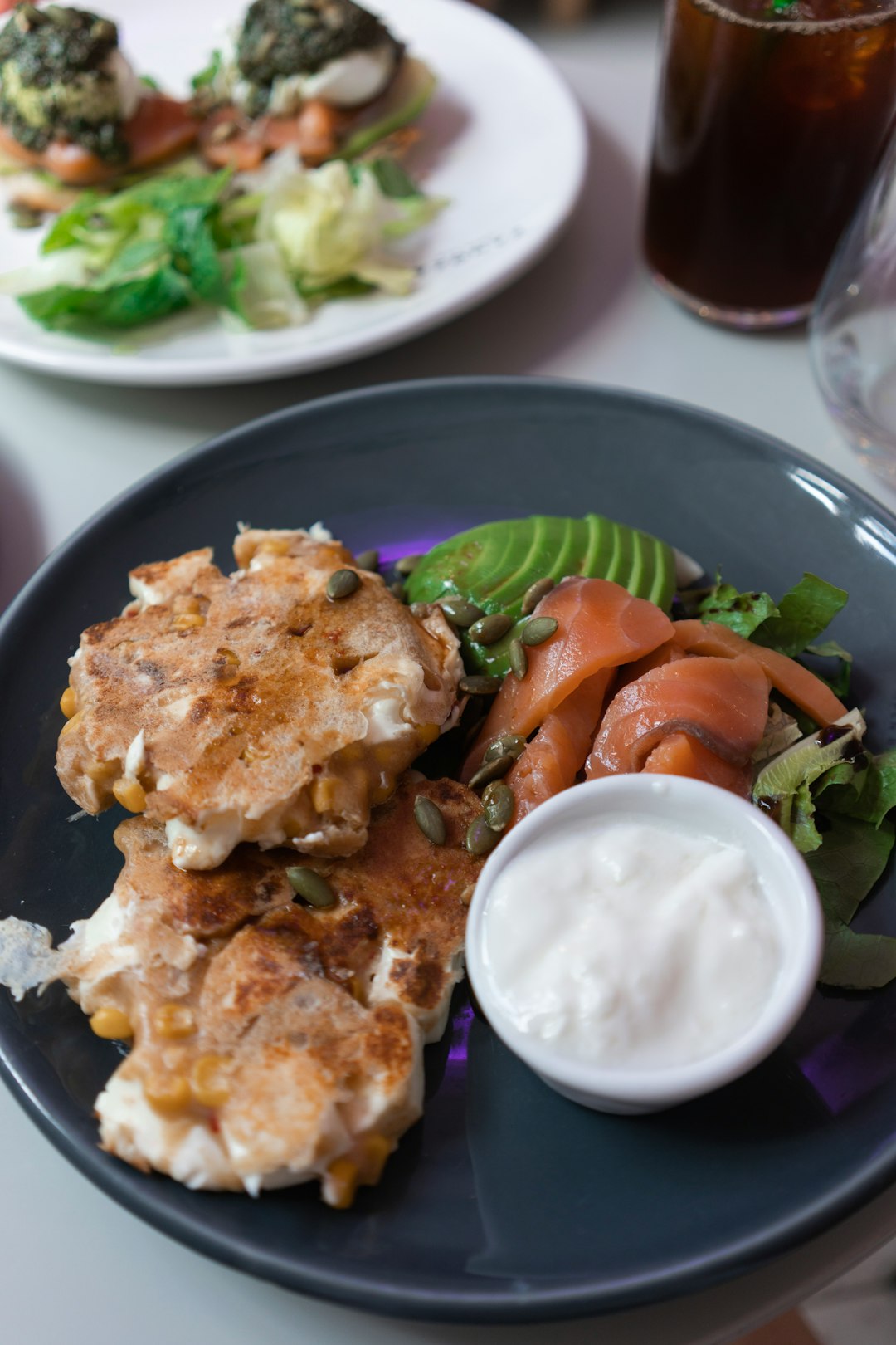 fried chicken with green vegetable and white cream on blue ceramic plate