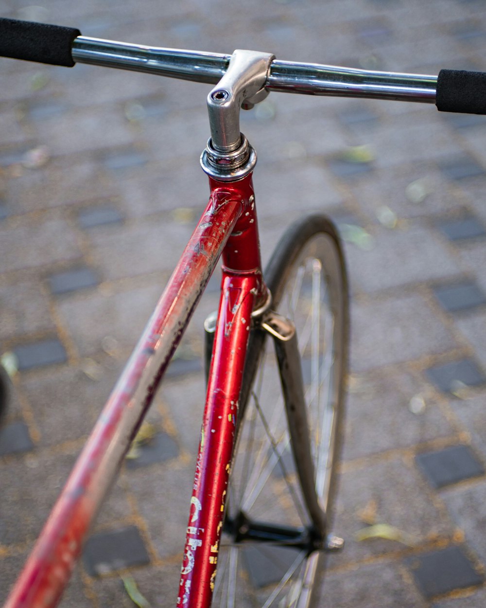red and black bicycle on gray concrete floor