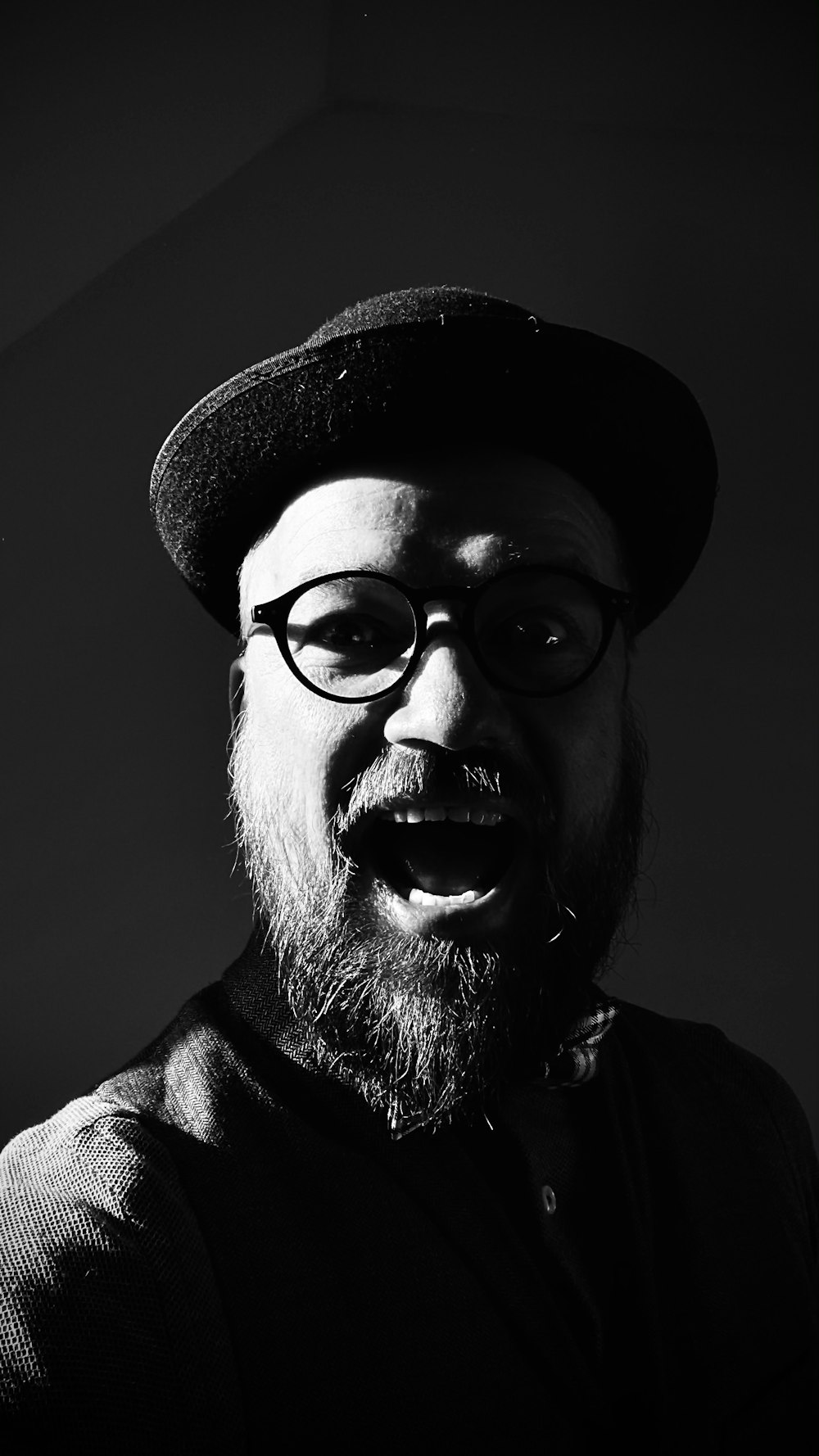 man in black framed eyeglasses and black hat