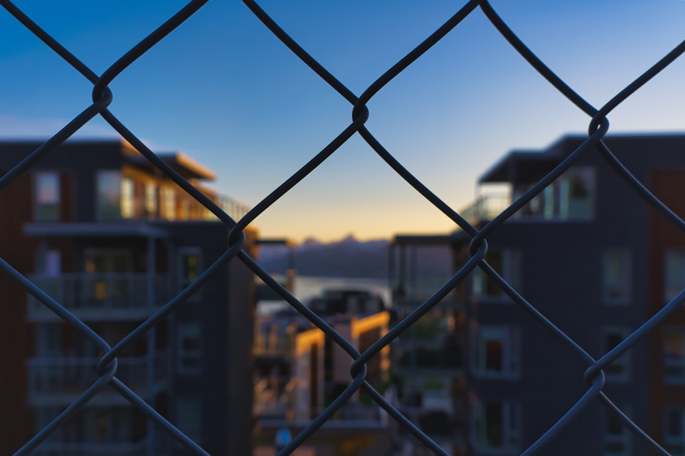 black metal fence near brown concrete building during daytime