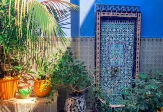 A vibrant mosaic side table adorned with plants.