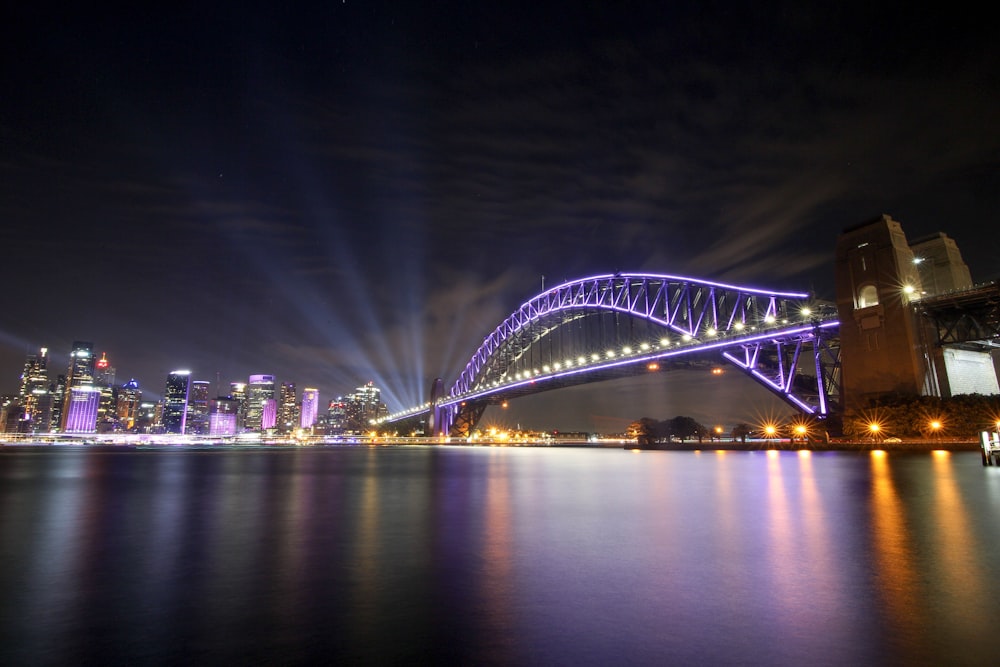 white bridge over body of water during night time