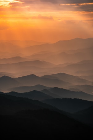 mountains under white clouds during daytime