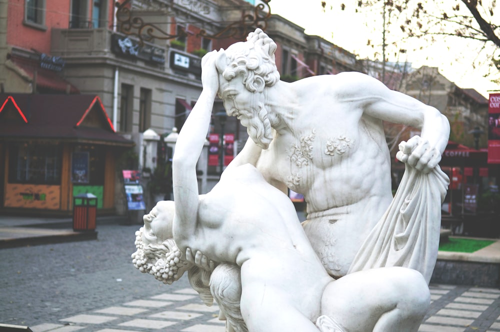 white concrete statue of a woman