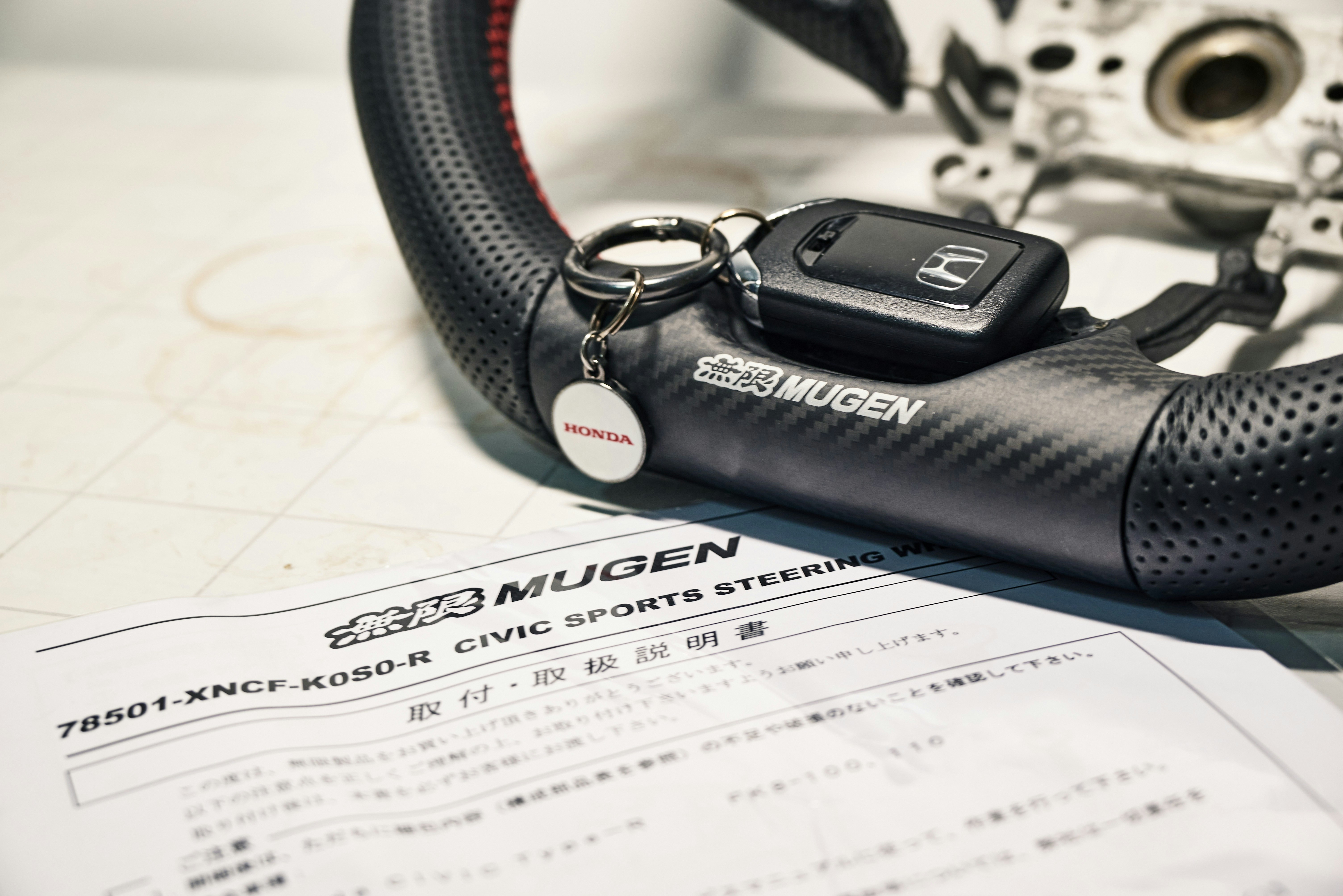 Service advisor holding a maintenance checklist on a clipboard next to a vehicle