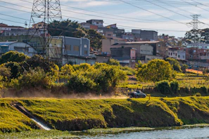 green grass field near body of water during daytime