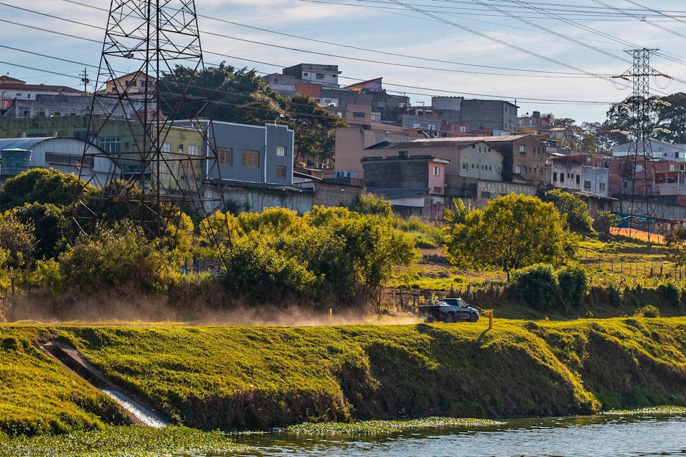 green grass field near body of water during daytime