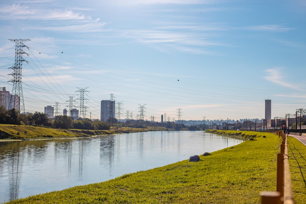 body of water near green grass field during daytime