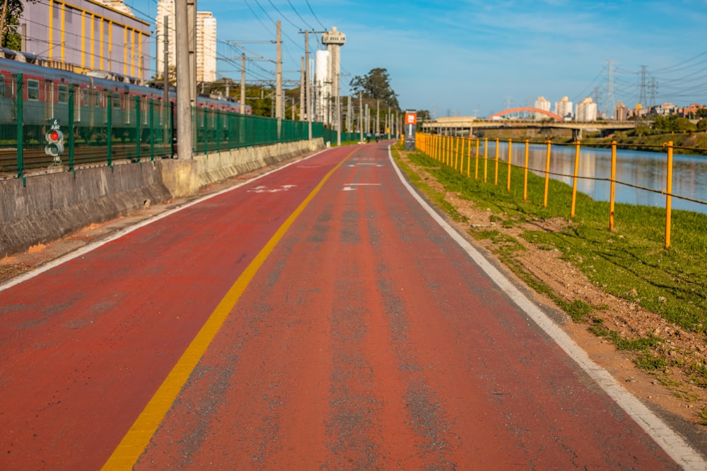 brown road between green grass field during daytime