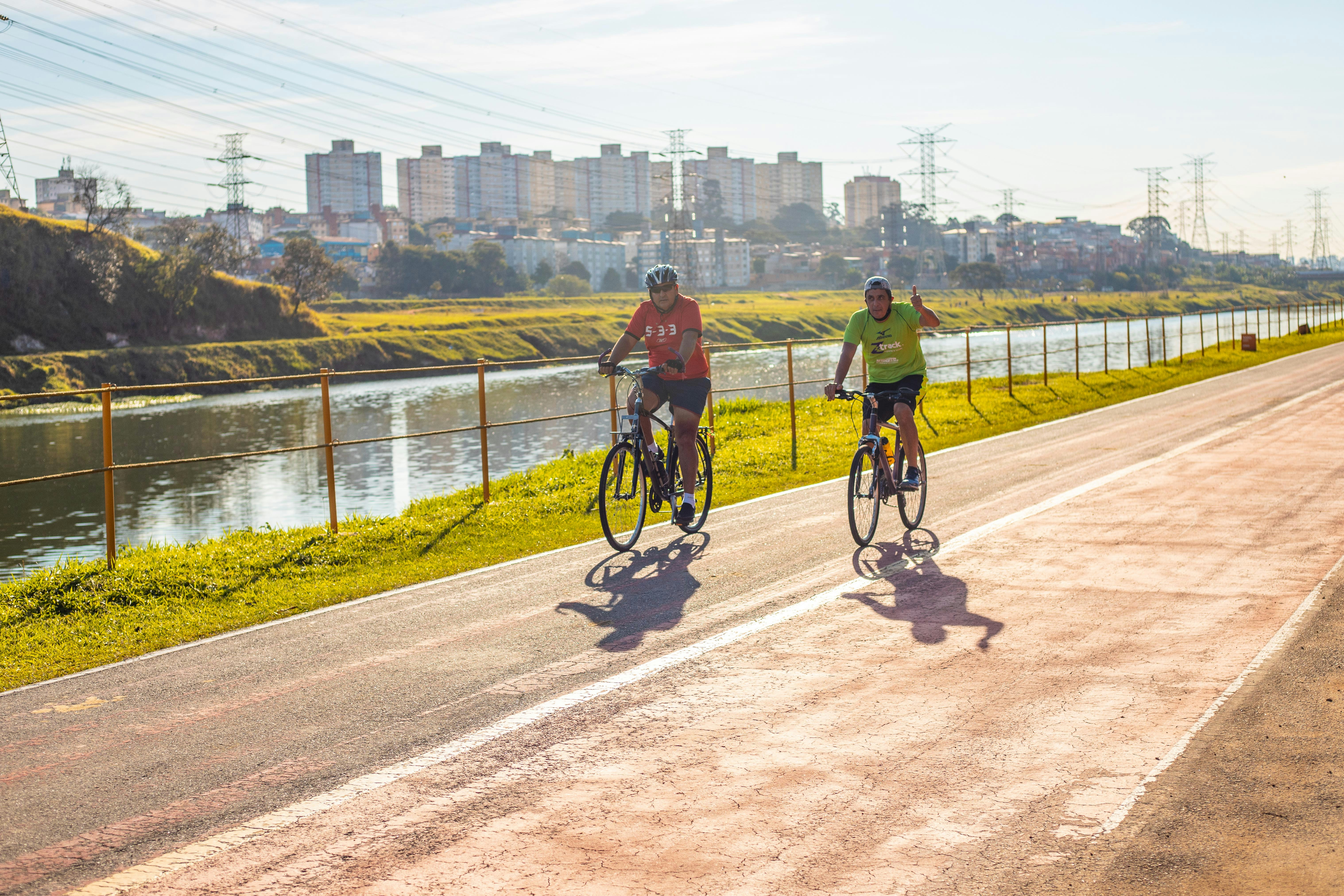 man in black jacket riding bicycle on road during daytime