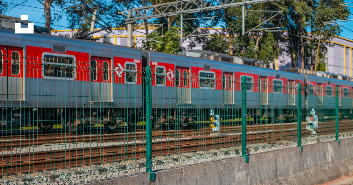 Red and green train on rail tracks during daytime photo – Free Cptm ...