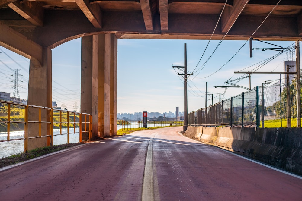 gray concrete road under bridge during daytime