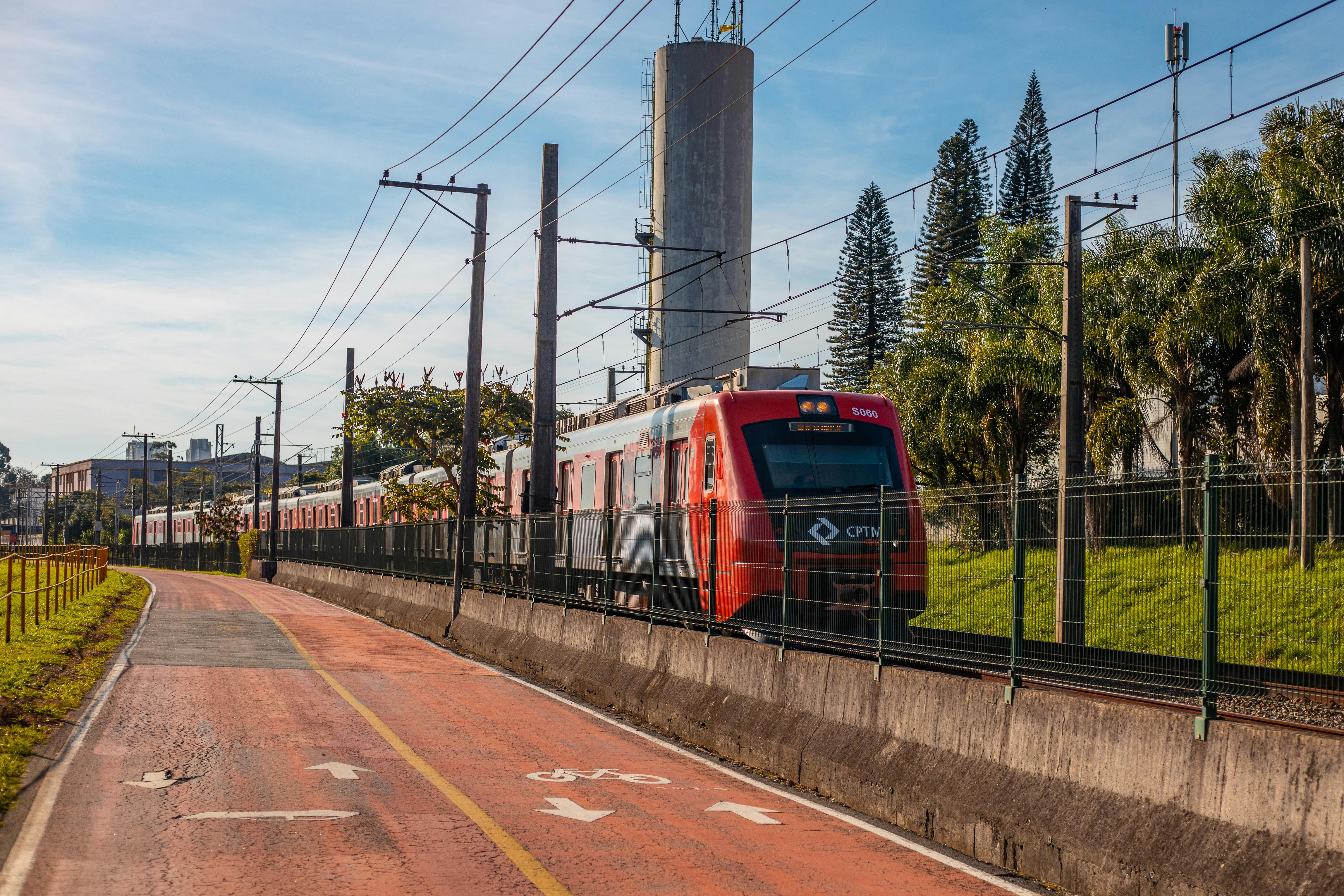 red train on rail road during daytime