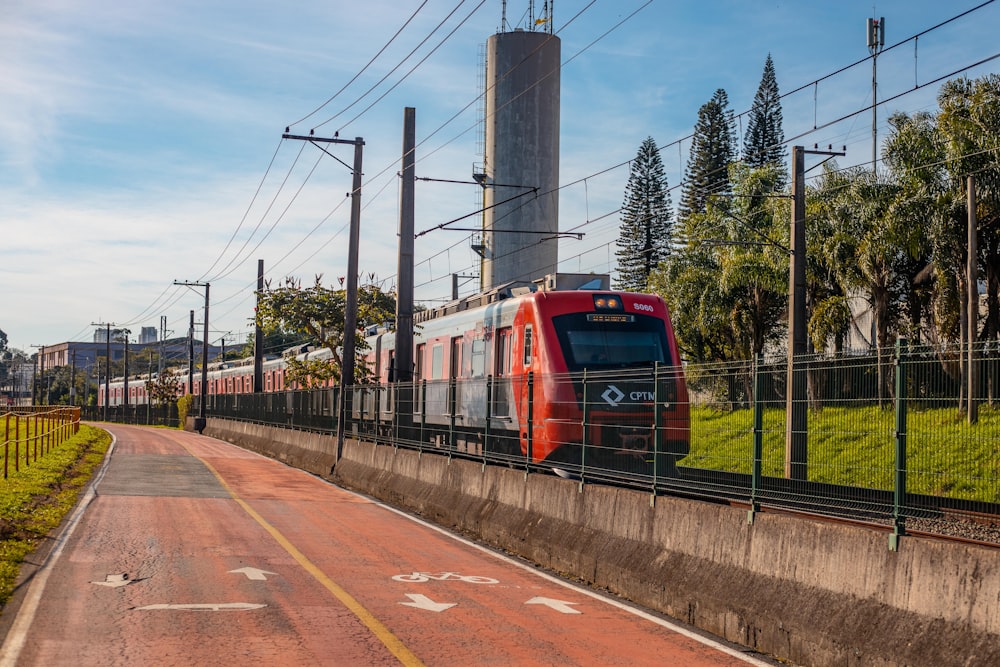 red train on rail road during daytime