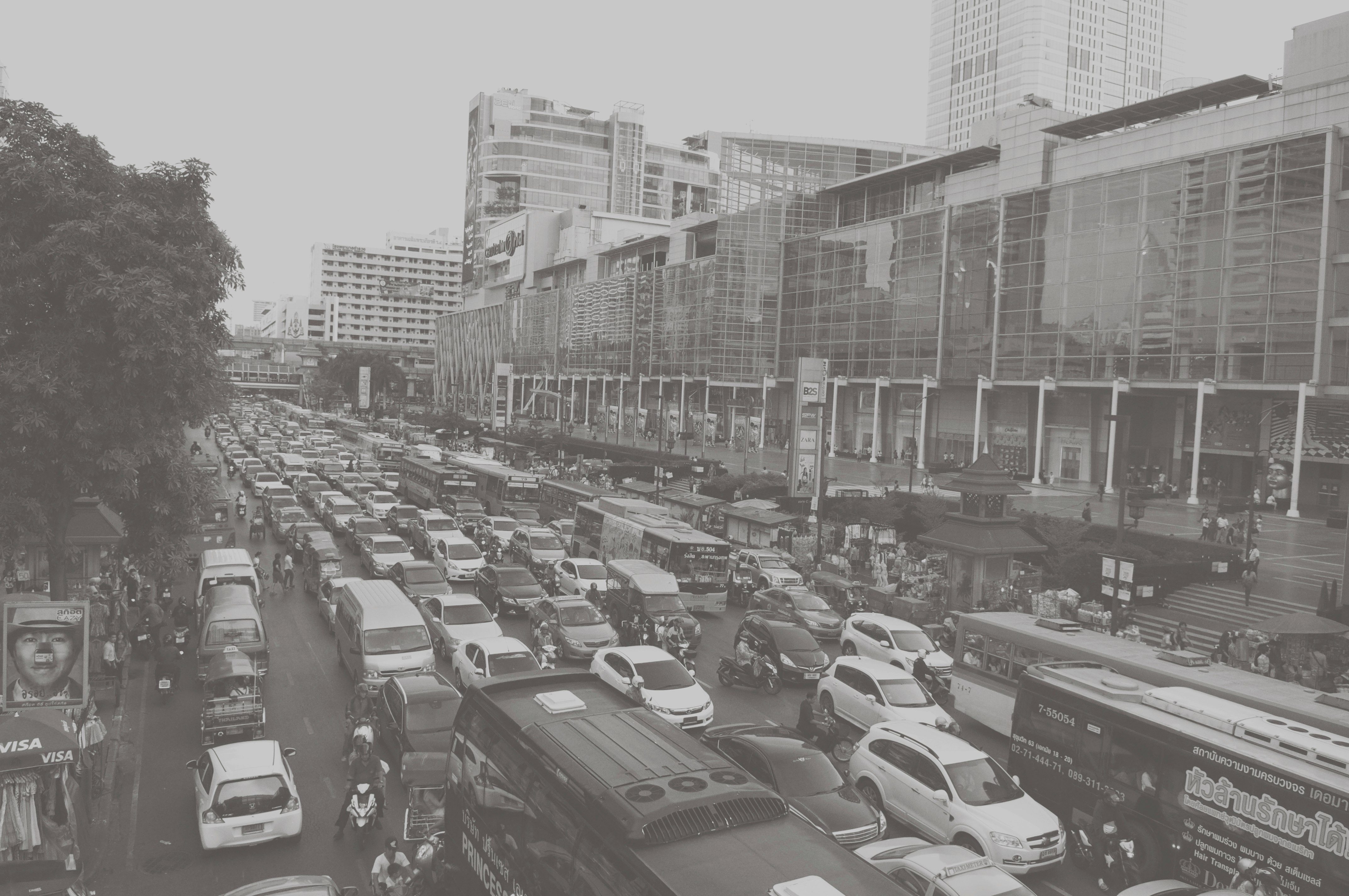 cars parked on parking lot near high rise buildings during daytime