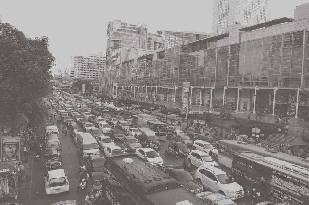 cars parked on parking lot near high rise buildings during daytime