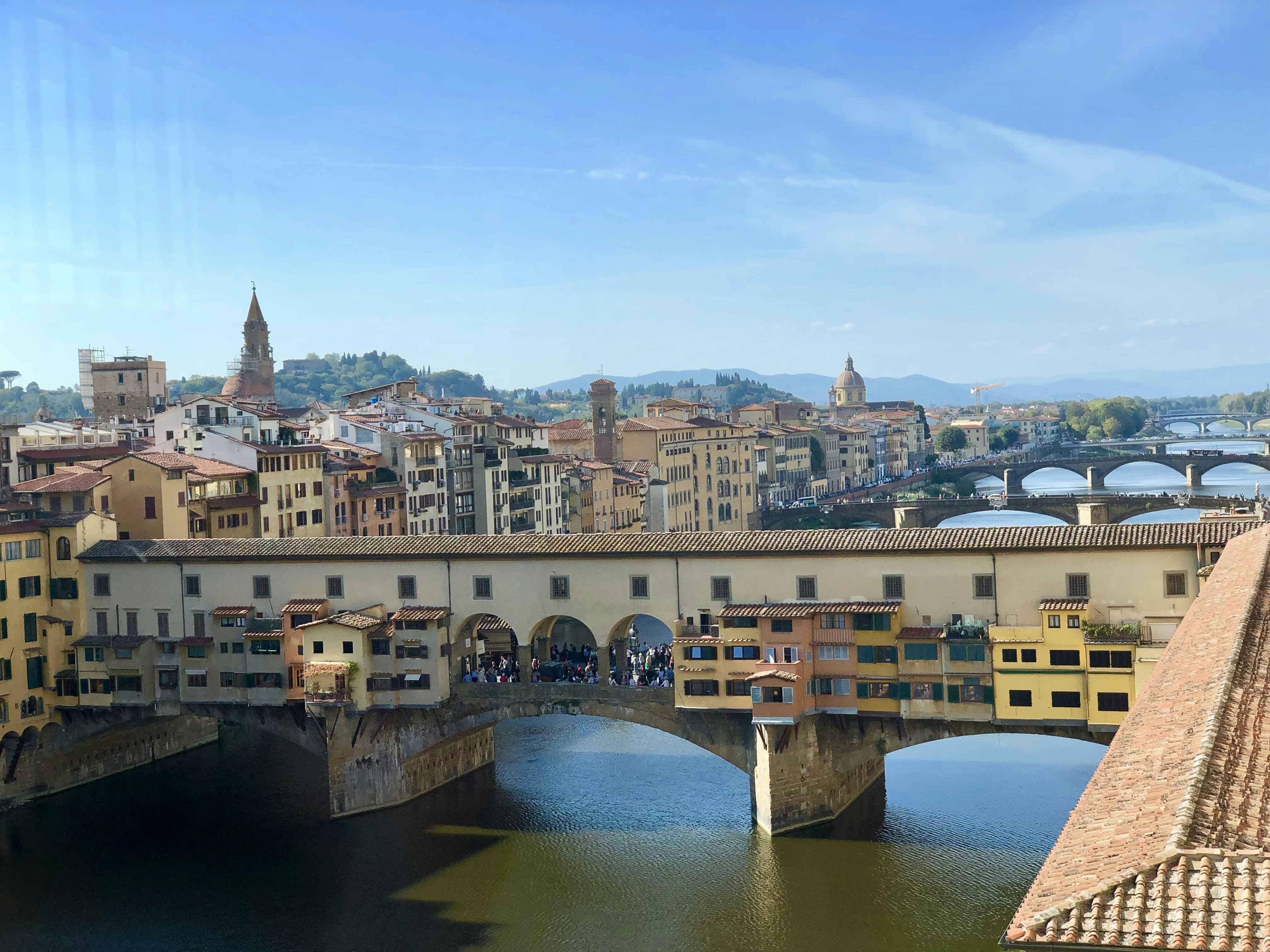 Brown concrete bridge over river during daytime