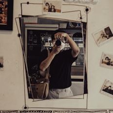 man in black tank top and white pants