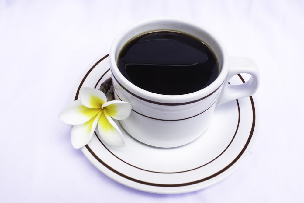 white ceramic teacup with saucer