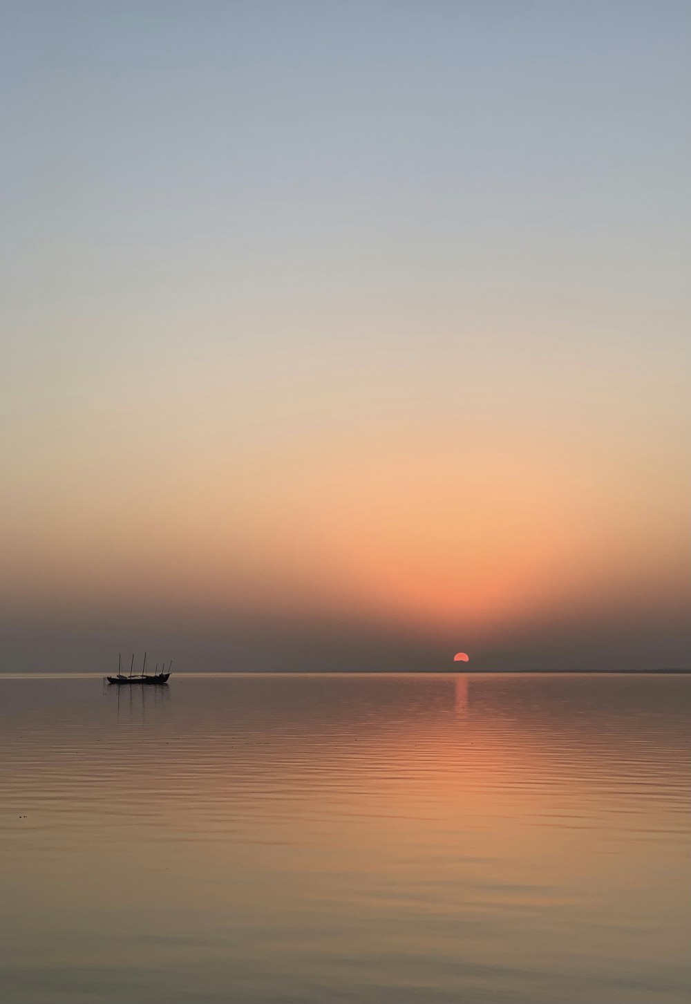 calm sea under orange sky during sunset