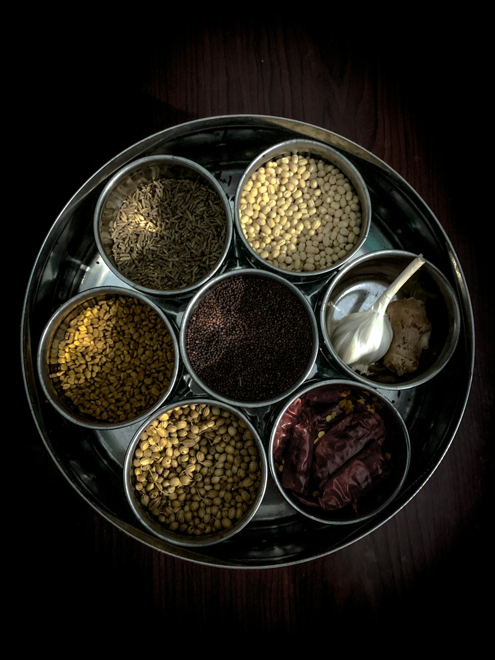 brown and black beans in stainless steel bowls