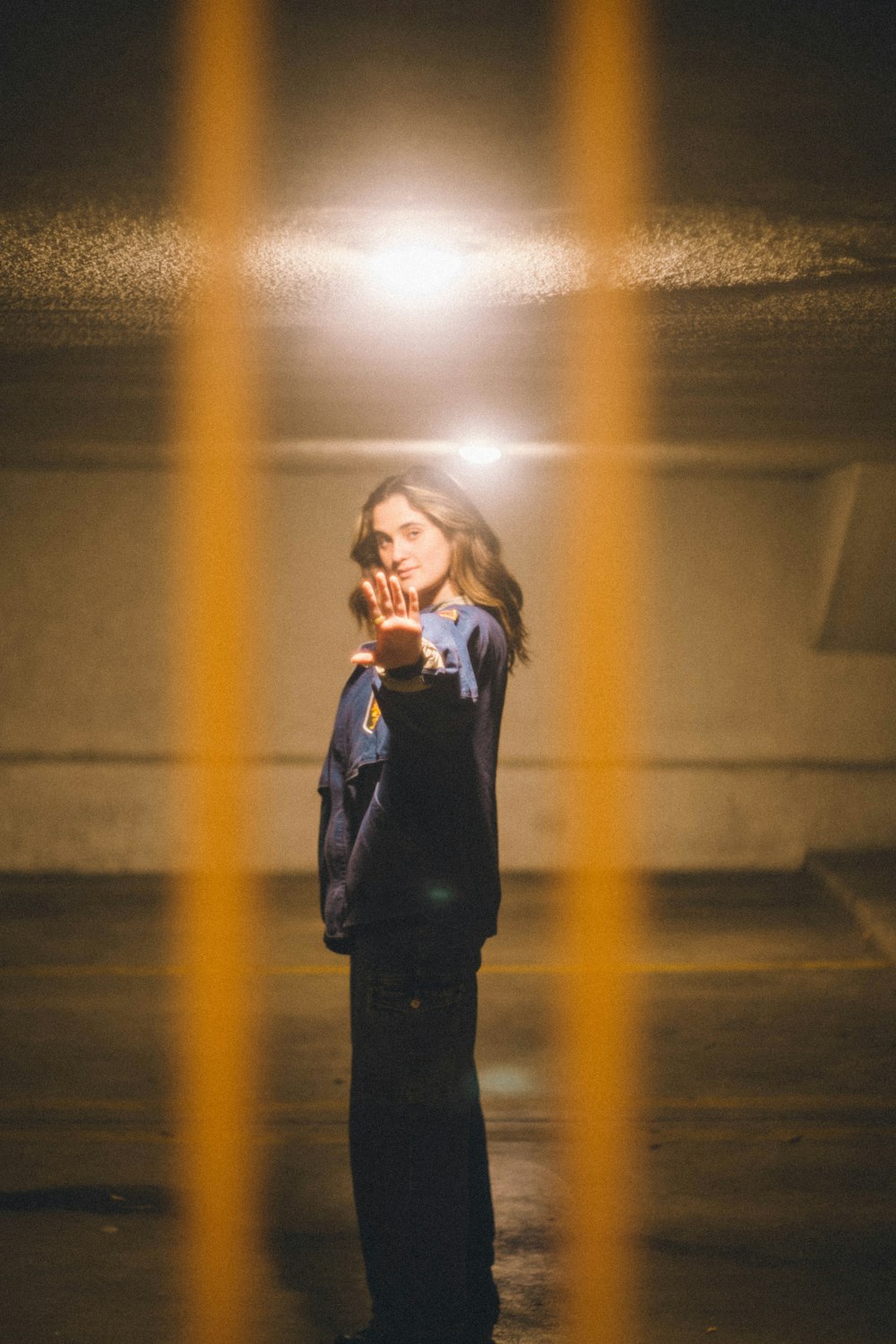 woman in black coat standing on hallway