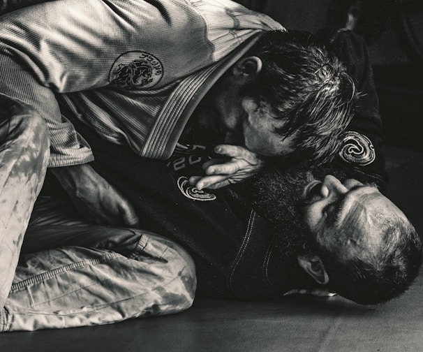 man in black shirt lying on floor