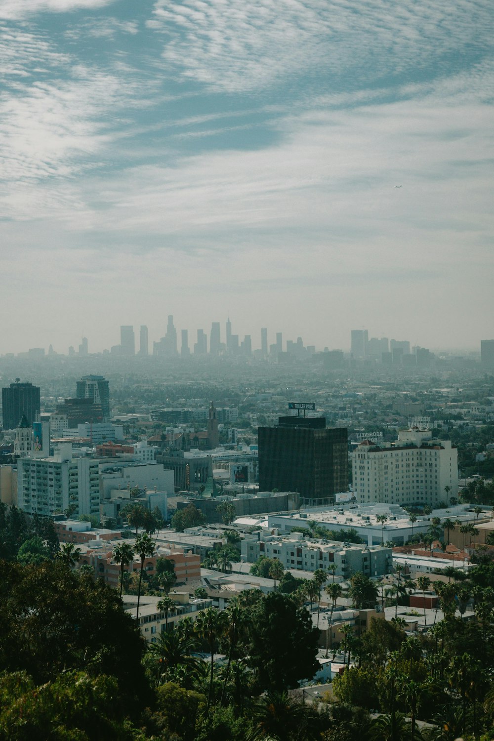 city skyline under white clouds during daytime