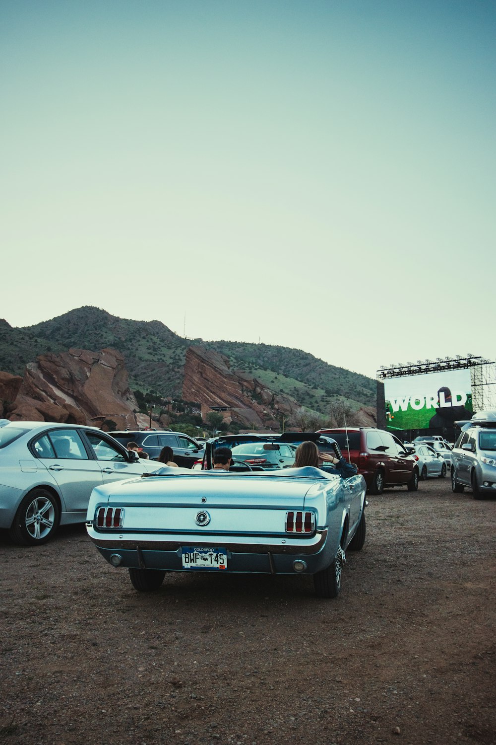 blue chevrolet camaro parked on brown soil during daytime