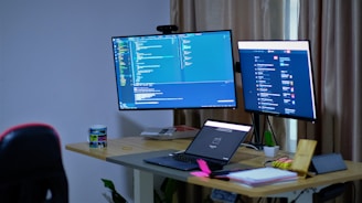 black flat screen tv turned on on white table