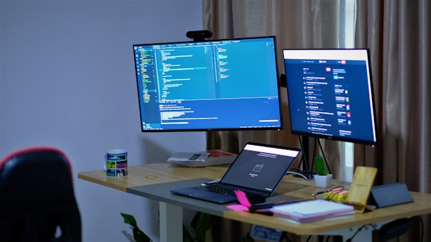 black flat screen tv turned on on white table