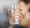 person holding clear drinking glass