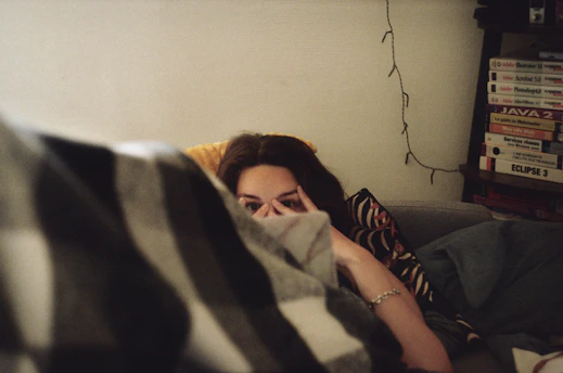 woman in black shirt lying on bed