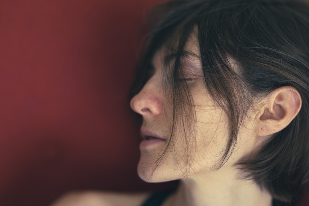 woman with black hair looking down