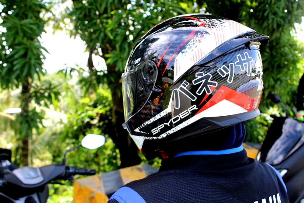 person wearing black and red motorcycle helmet