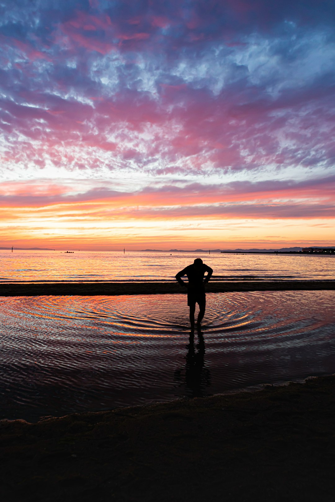 silhouette of person standing on beach during sunset