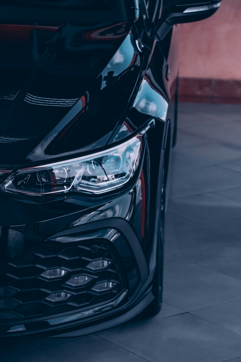 black and red car on gray pavement