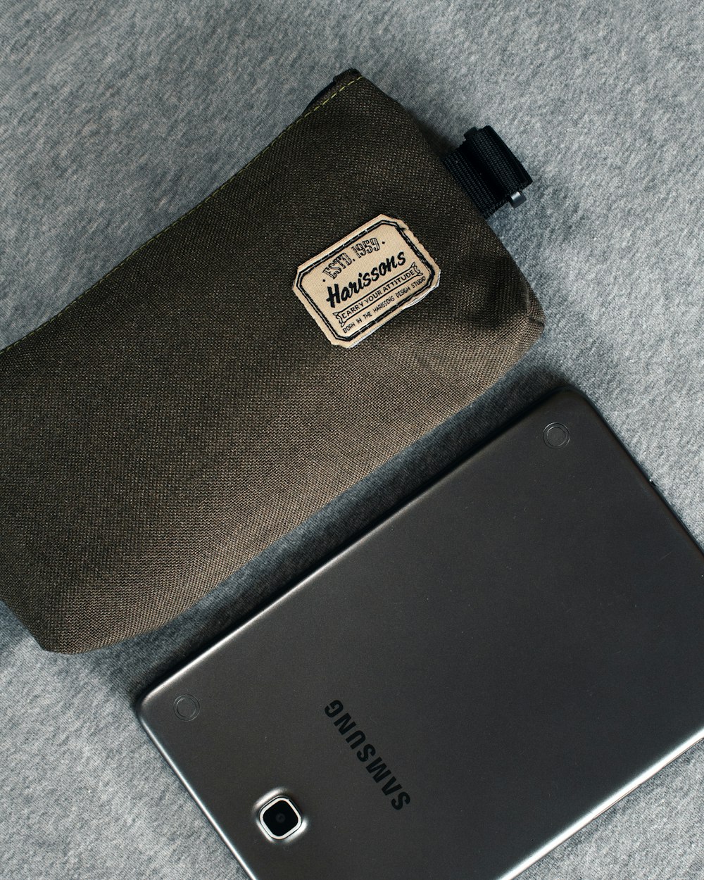 black samsung android smartphone on gray textile