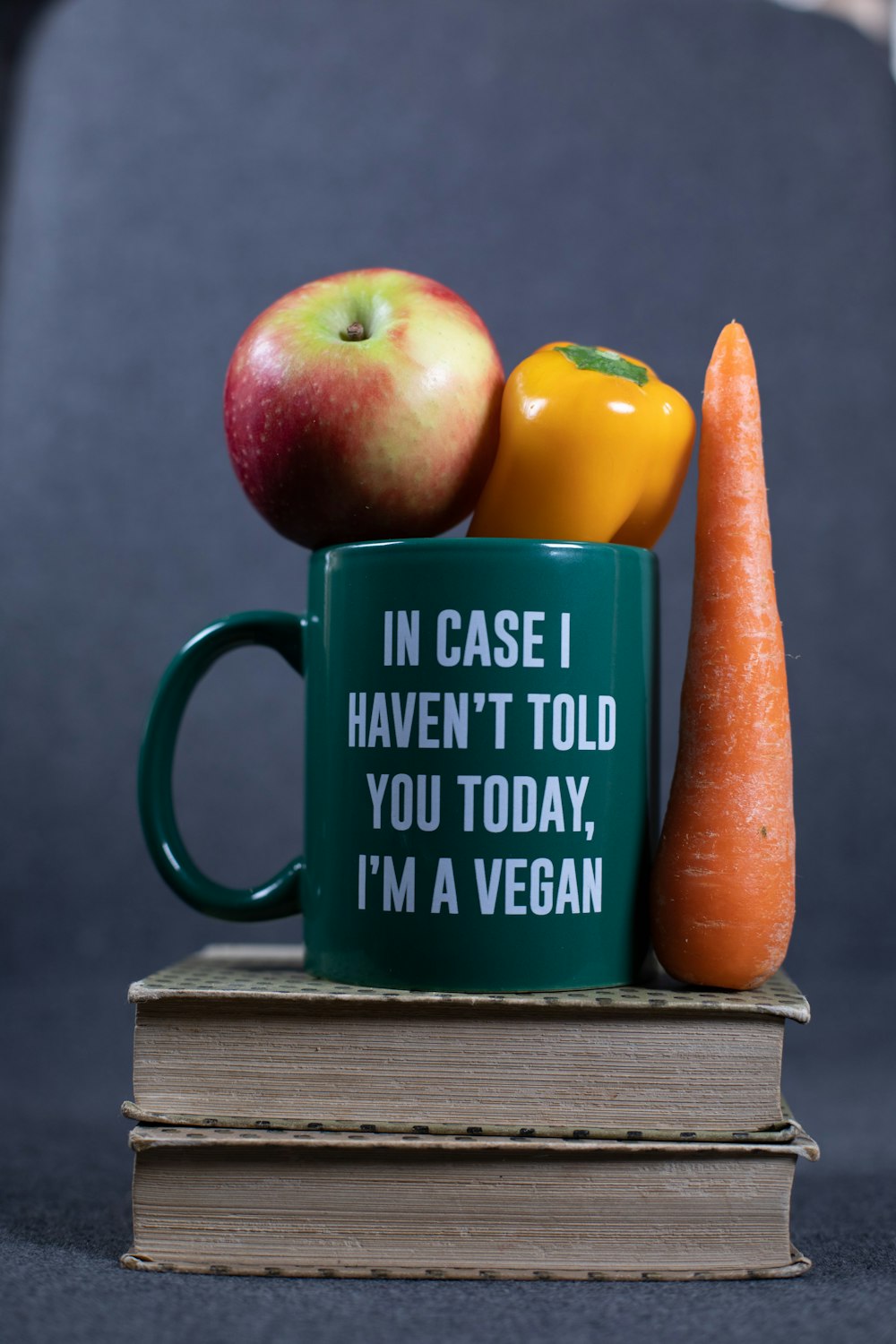 green and yellow ceramic mug with brown carrot
